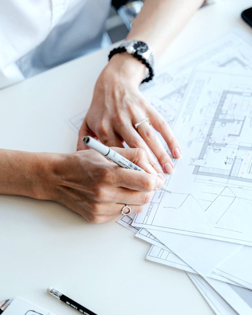 Hands working on a floor plan